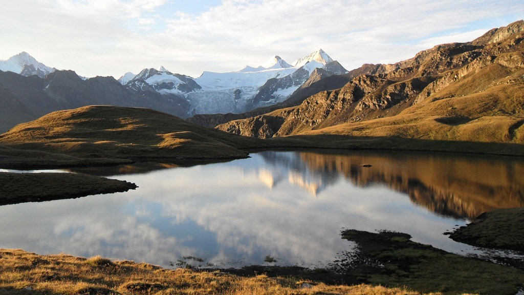 Lac des Autannes (2686 m) on the route to Sasseneire. Early morning view of Dent Blanche group.