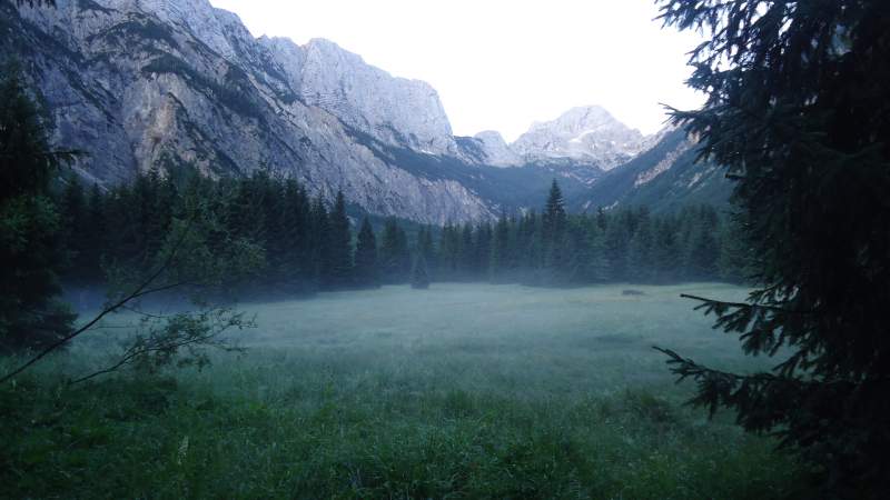 This is the beginning of the route from the Zadnja Trenta Valley, near the Soca river source, in an early morning. Bavski Grintavec mountain behind.