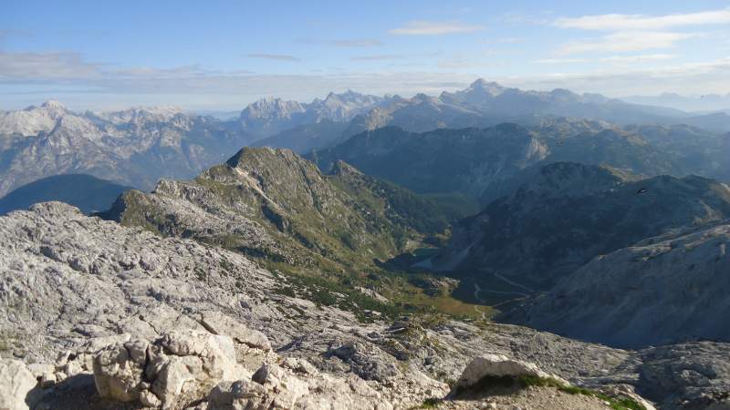 The summit view of the north side route, the lake is far below. The highest Slovenian mountains are in the background, Triglav included.