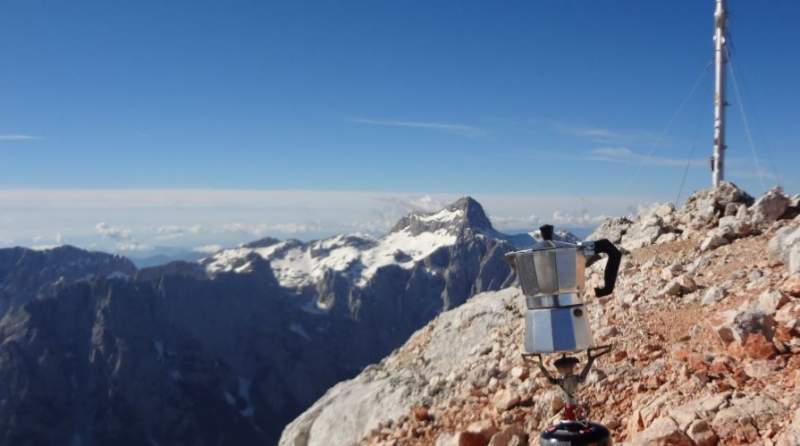 Coffee on the summit with Triglav in the background.