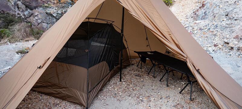 View with a standard freestanding tent and a cot inside.