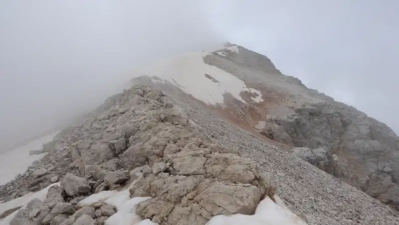 Areas with snow below the summit. This is late July.