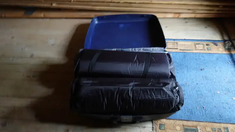 Inflatable mattrasses stored in a suitcase.